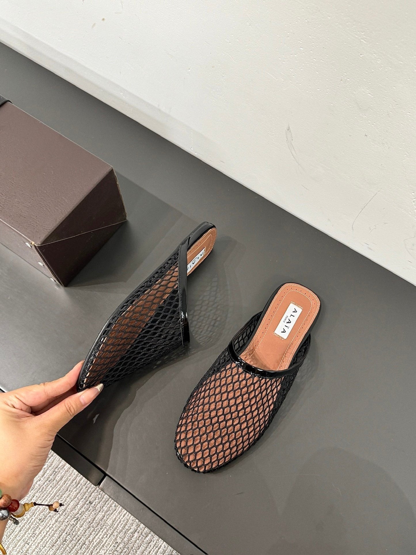 ALAIA FLAT MULES IN BLACK MESH FISHNET
