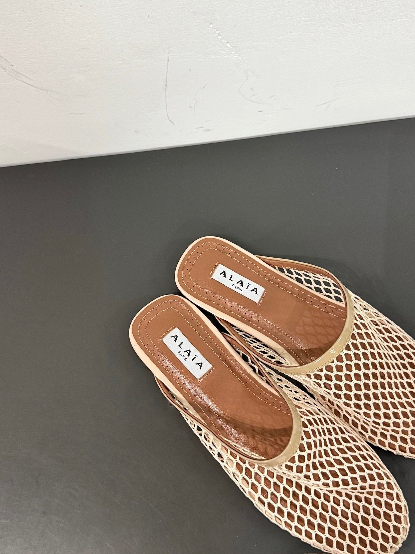 ALAIA FLAT MULES IN BEIGE MESH FISHNET