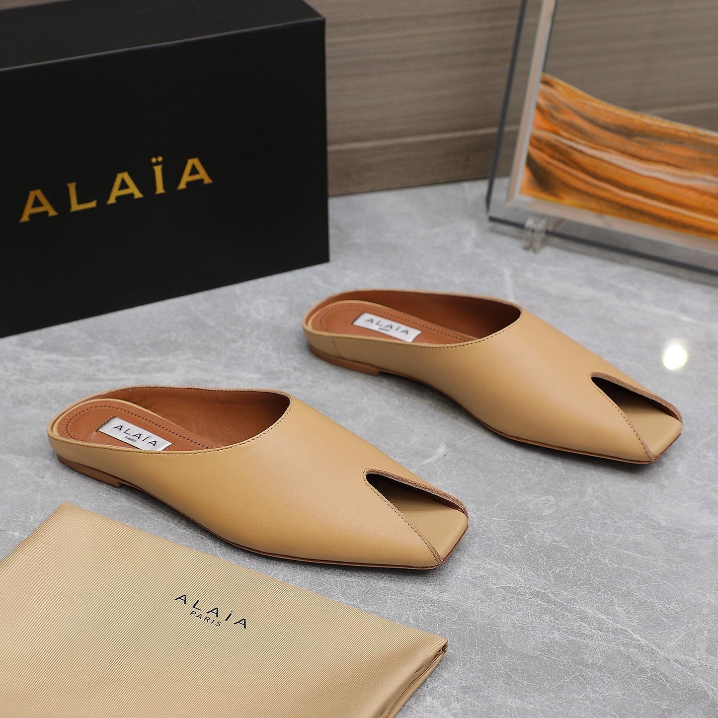 ALAIA FLAT MULE IN SEPIA TAN LAMBSKIN